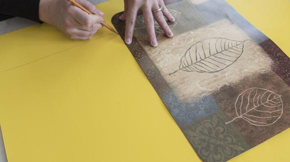 Tracing a placemat shape on yellow paper