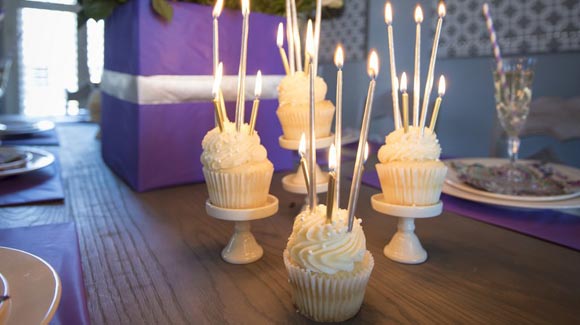 Cupcakes on cupcake stands with candles